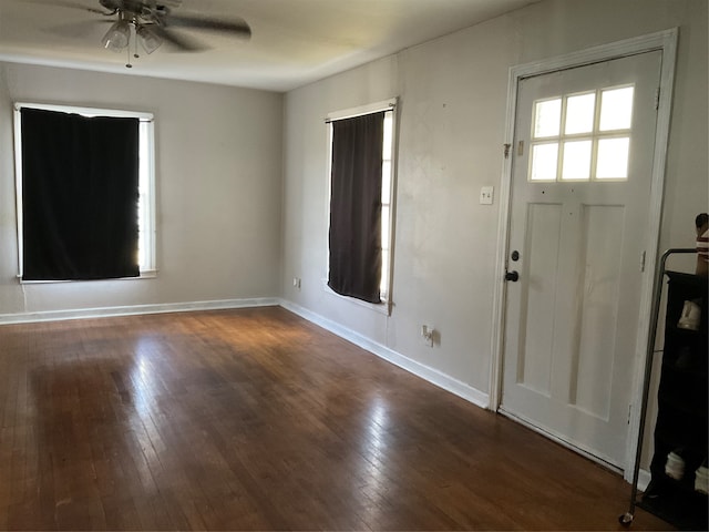 entryway with dark wood-type flooring and ceiling fan