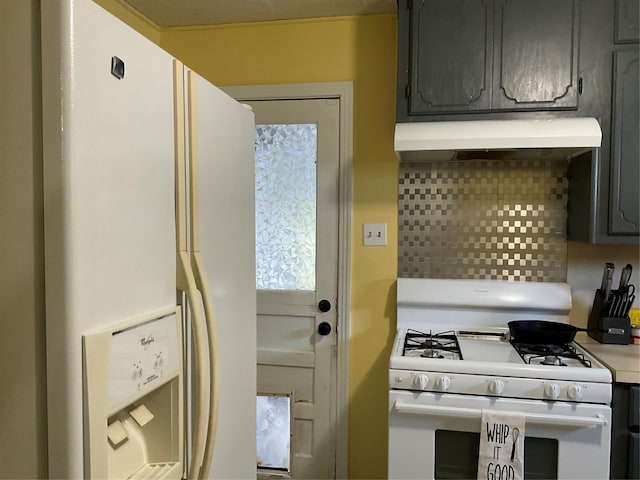 kitchen with backsplash, gray cabinetry, and white appliances