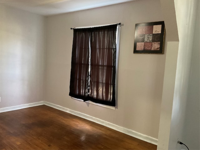 unfurnished room featuring dark hardwood / wood-style flooring