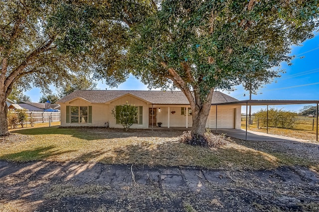 ranch-style home featuring a garage, a front lawn, and a carport