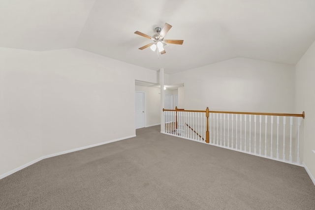 spare room featuring vaulted ceiling, carpet floors, and ceiling fan