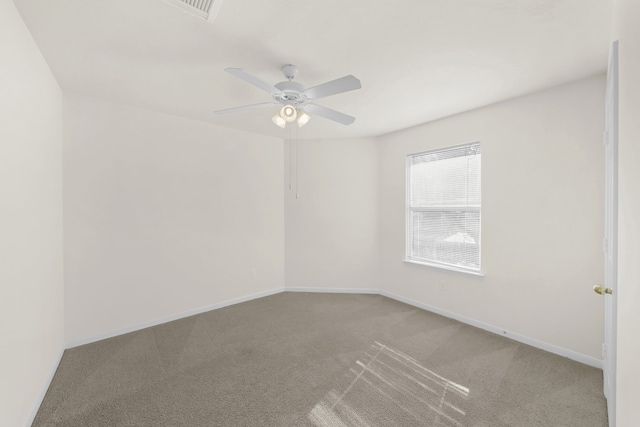 empty room featuring carpet flooring and ceiling fan