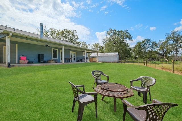 view of yard featuring ceiling fan and a patio area