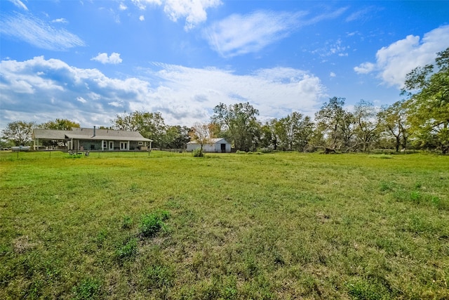 view of yard with a rural view