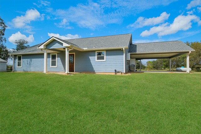 10723 Fm 442nd Rd, Boling, TX 77420 - view of front of property with a front lawn, an attached carport, and roof with shingles