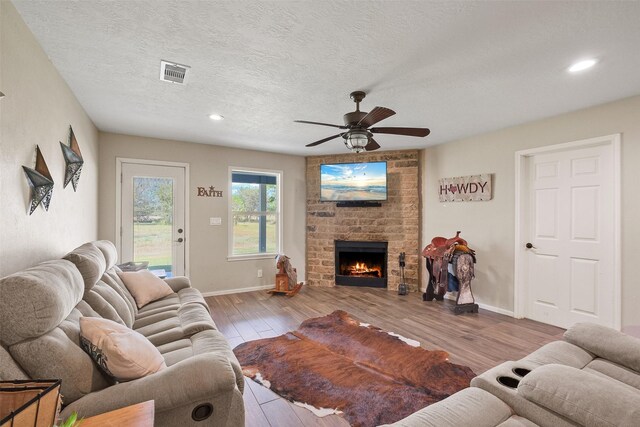 10723 Fm 442nd Rd, Boling, TX 77420 - living area featuring a ceiling fan, wood finished floors, baseboards, a fireplace, and recessed lighting