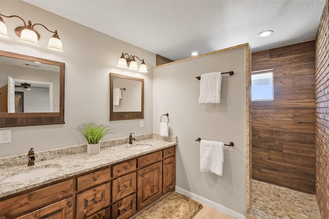 bathroom with a shower and vanity