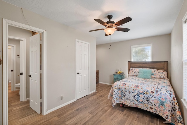 10723 Fm 442nd Rd, Boling, TX 77420 - bedroom featuring wood finished floors, baseboards, and ceiling fan