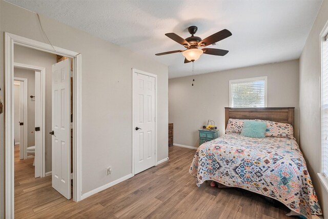 10723 Fm 442nd Rd, Boling, TX 77420 - bedroom featuring wood finished floors, baseboards, and ceiling fan