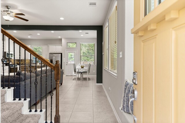 tiled entrance foyer featuring ceiling fan