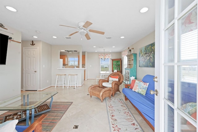 living room featuring visible vents, recessed lighting, light tile patterned floors, and ceiling fan with notable chandelier