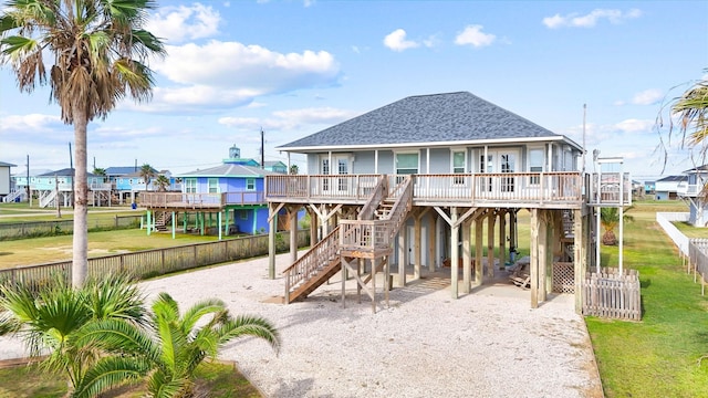 view of play area with covered porch, stairway, and fence