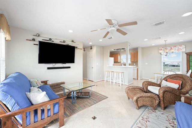 living area featuring light tile patterned floors, visible vents, ceiling fan, baseboards, and recessed lighting