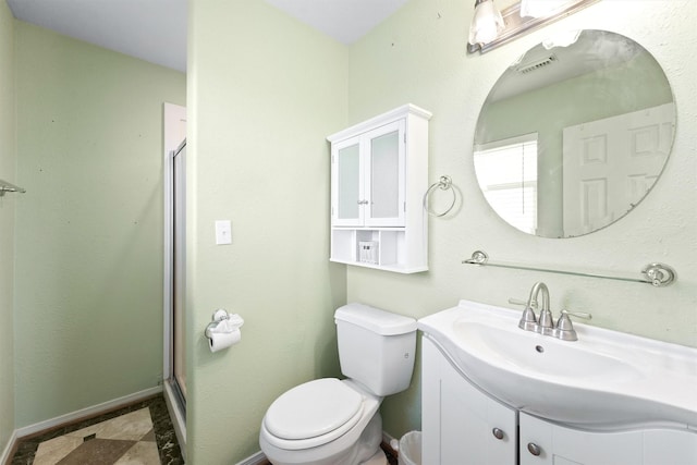 bathroom with vanity, toilet, a stall shower, visible vents, and baseboards