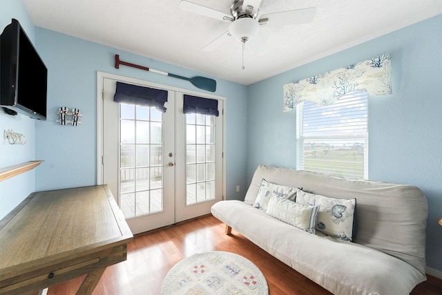interior space featuring wood finished floors, french doors, and ceiling fan