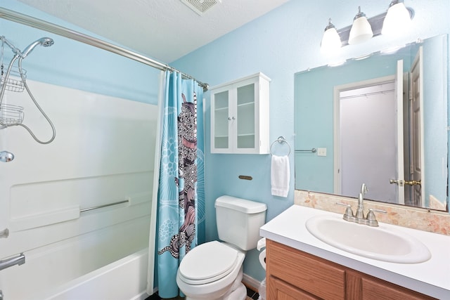 full bathroom featuring vanity, shower / bath combo with shower curtain, a textured ceiling, and toilet