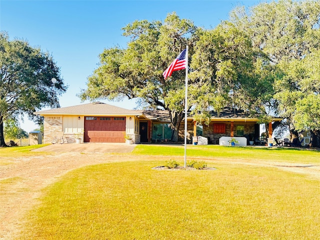 ranch-style house featuring a front yard and a garage