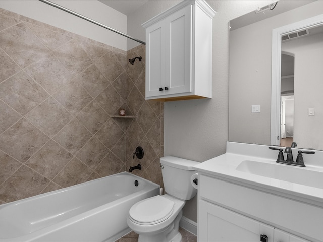 full bathroom with vanity, tiled shower / bath combo, and toilet