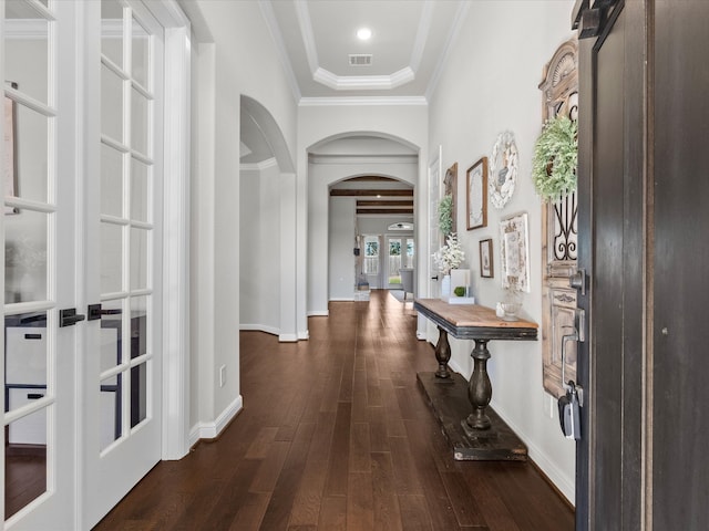 corridor with dark wood-type flooring, french doors, and ornamental molding