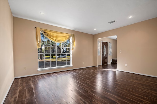 spare room with dark wood-type flooring