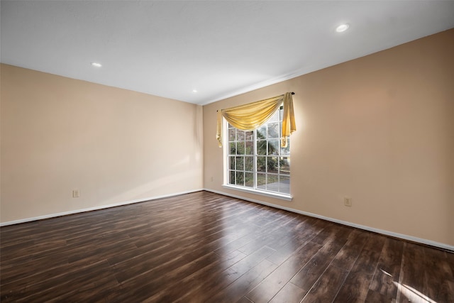 empty room with dark hardwood / wood-style floors