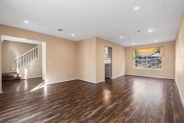 unfurnished living room with dark hardwood / wood-style flooring