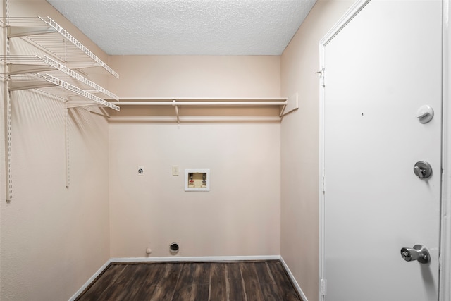 washroom with electric dryer hookup, hookup for a washing machine, dark hardwood / wood-style floors, and a textured ceiling