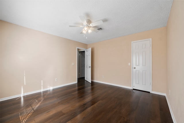 spare room featuring ceiling fan, a textured ceiling, and dark hardwood / wood-style flooring