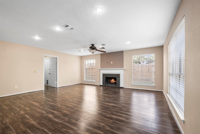 unfurnished living room with ceiling fan and dark hardwood / wood-style flooring