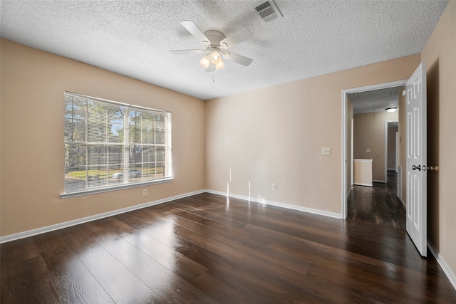 spare room featuring a textured ceiling, dark hardwood / wood-style floors, and ceiling fan