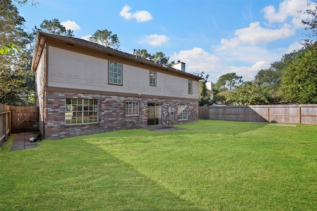 rear view of property with a yard