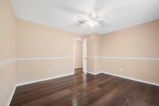 spare room with ceiling fan, a textured ceiling, and dark hardwood / wood-style flooring