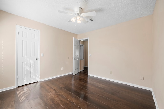 unfurnished bedroom with ceiling fan, a textured ceiling, and dark hardwood / wood-style flooring