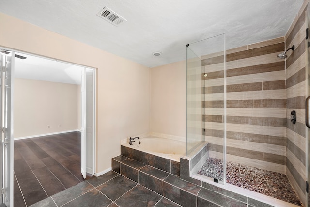 bathroom with independent shower and bath and wood-type flooring