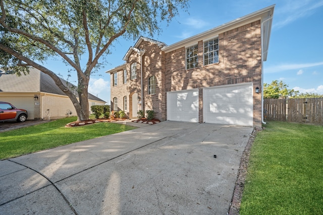 view of front of property with a front yard and a garage