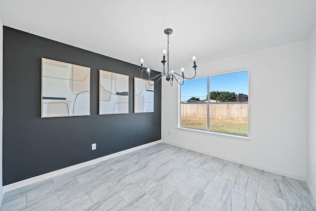 unfurnished dining area with a notable chandelier