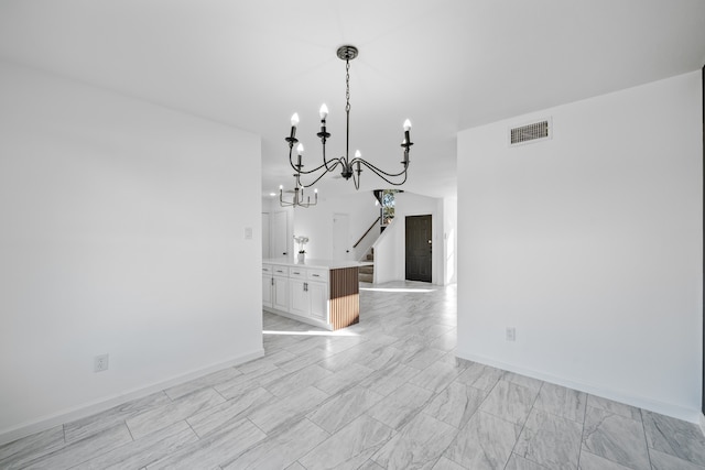 unfurnished dining area featuring a notable chandelier