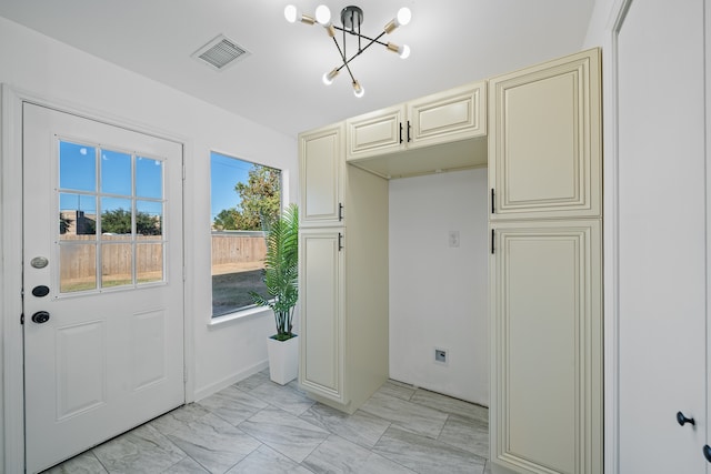 doorway with a notable chandelier