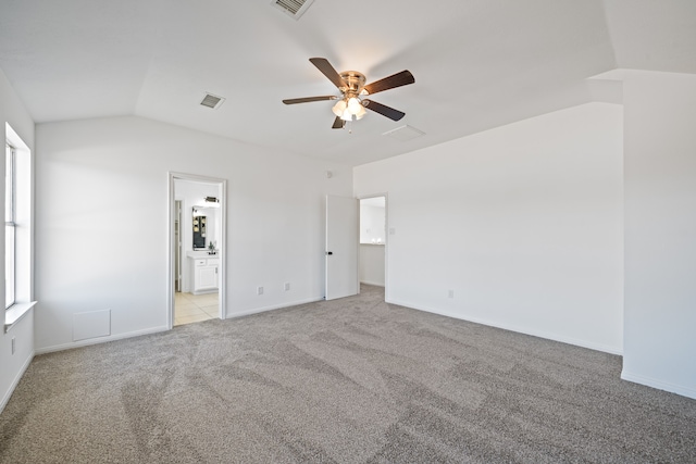 spare room with lofted ceiling, light colored carpet, and ceiling fan