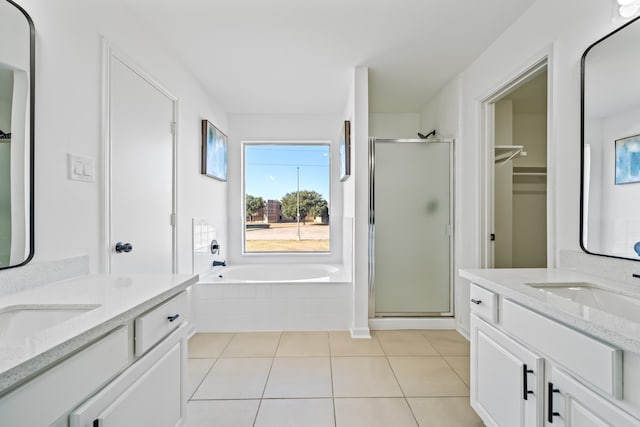 bathroom featuring vanity, plus walk in shower, and tile patterned flooring