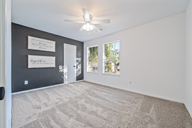 empty room featuring carpet flooring and ceiling fan