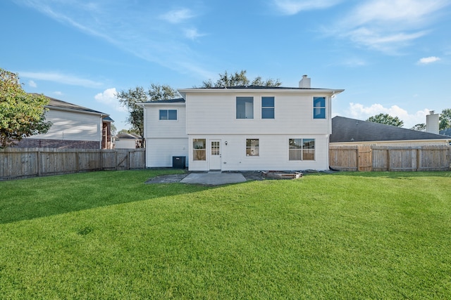 rear view of property featuring a patio area, central AC, and a lawn