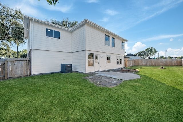 rear view of property with a yard, a patio area, and central air condition unit