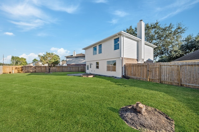 rear view of property with a lawn