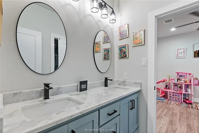 bathroom with vanity and hardwood / wood-style floors