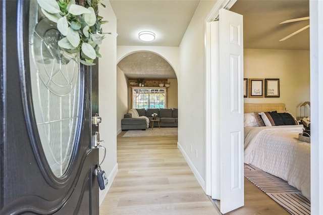 foyer with light hardwood / wood-style floors and ceiling fan