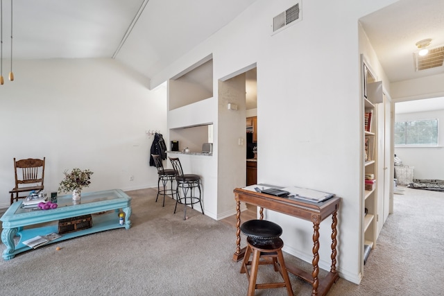 corridor featuring carpet and vaulted ceiling