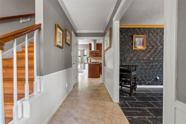 corridor featuring a textured ceiling and crown molding