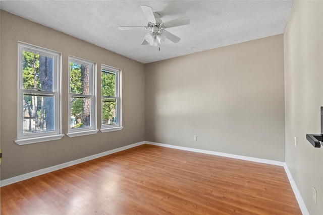 empty room featuring a textured ceiling, ceiling fan, and light hardwood / wood-style floors