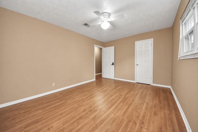 unfurnished bedroom with ceiling fan, light hardwood / wood-style flooring, and a textured ceiling